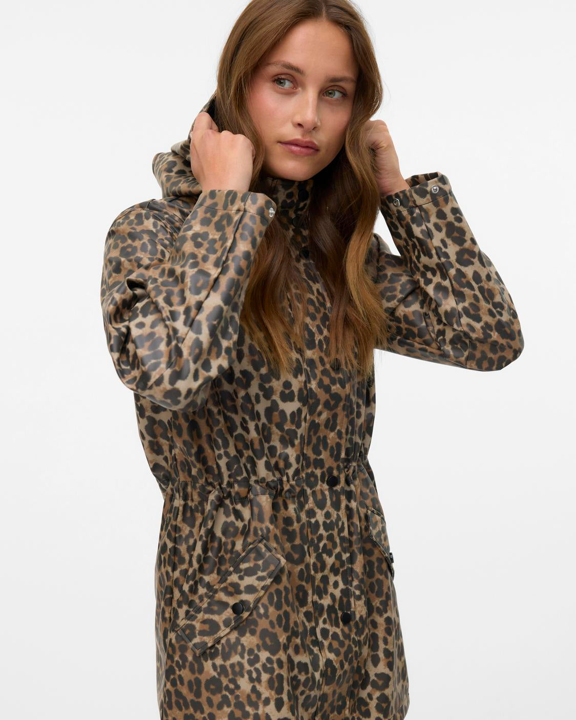 Woman wearing a leopard print coat on a white background